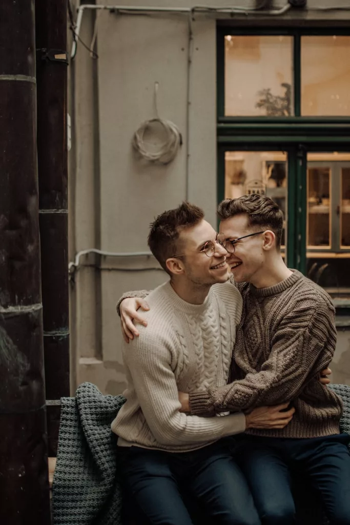 man in gray sweater sitting beside woman in gray sweater